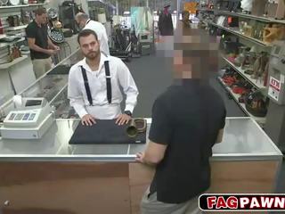 Dude blows a penis behind counter in a shop